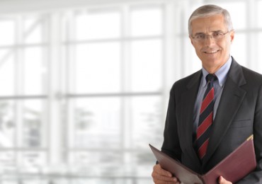 Mature Businessman Holding Folder